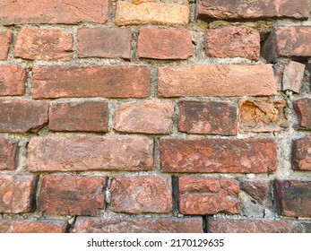 An Old Wall Made Of Red Brick, Partially Damaged. Background, Surface. Shot On IPhone SE 2020