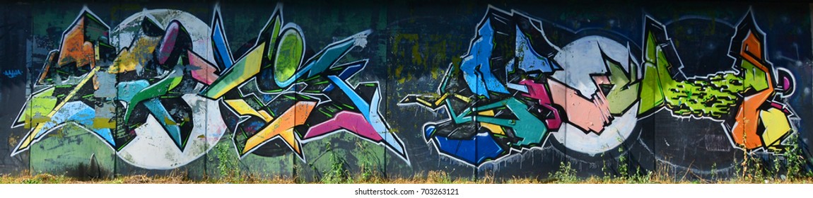 The old wall, painted in color graffiti drawing with aerosol paints. Background image on the theme of drawing graffiti and street art