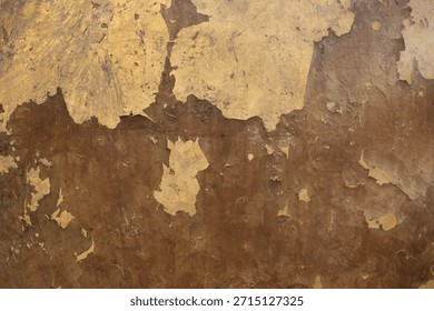 The old wall surface is rough and has abstract vintage golden cracks.