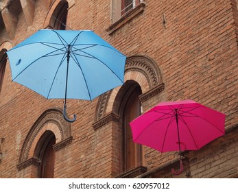 Old wall and two colored umbrellas.
