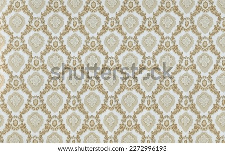 Old wallpaper on the wall. Old wallpaper for texture or background.