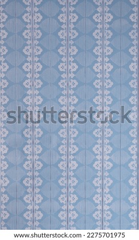 Old wallpaper on the wall. Old wallpaper for texture or background.