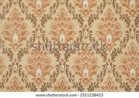 Old wallpaper on the wall. Old wallpaper for texture or background.