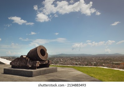 old war cannon in viewpoint of the city of Puebla, sunny summer day, for vacationers, no people - Shutterstock ID 2134883493