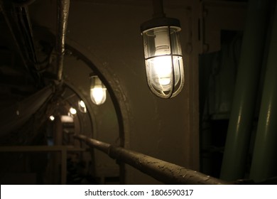 Old War Ship Lighted Up Narrow Corridor, Vintage Lamps