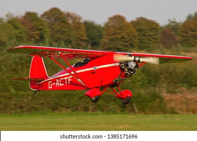 OLD WARDEN, BEDFORDSHIRE, UK – OCTOBER 5, 2014: Comper CLA.7 Swift G-ACTF, a British 1930s single-seat sporting aircraft produced by Comper Aircraft Company, makes its approach to land at Old Warden.