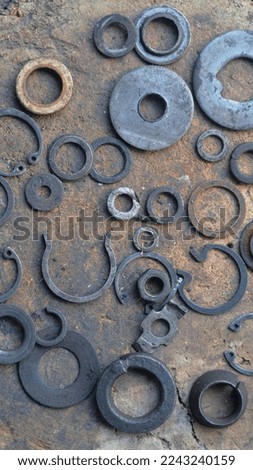old washers rings and stoppers flat and round locknuts lie on a plane 