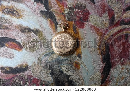 The old watch made of gold (colourful background)