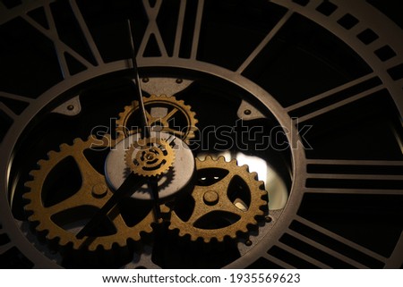 Old watch mechanism in the dark. Clock hands as symbol of time management