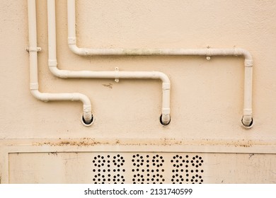 Old Water And Gas Metal Pipes Fixed In Front Of A Wall