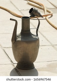 Old Water Jug On The Balcony, Hose