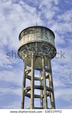 old water tank and cloudy sky