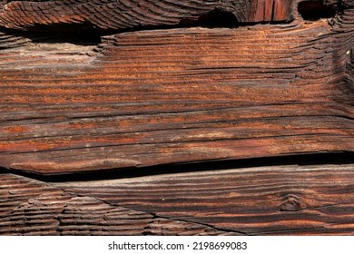 Old And Weathered Dark Brown Cracked Wood Beam Surface With Nice Rough Grain Texture.