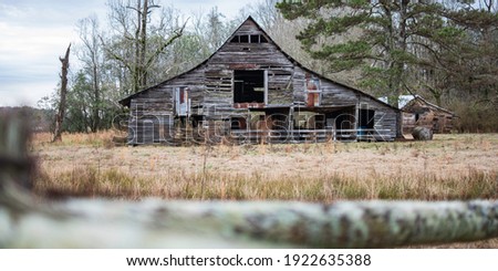An old, weathered and dilapidated barn in rural Alabama viewed in the winter.