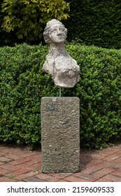 Old Weathered Female Bust On Stone Plinth