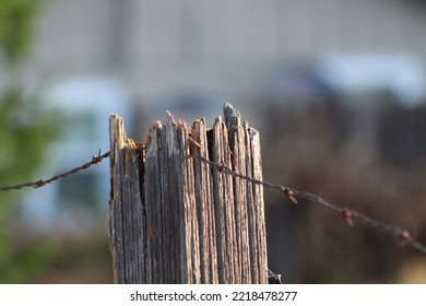 Old, Weathered Fence Post In The Neighborhood