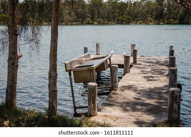 Old Weathered Jetty With Fish Cleaning Sink On The River At Sussex Inlet