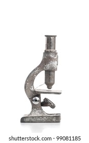 An old weathered microscope on a white background