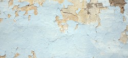 Old Weathered Painted Blue Plastered Peeled Interior Wall Background.  Cracked Flaked Shabby Wall With Rundown Stucco Layer Texture. Abstract Blue White Horizontal Empty Wallpaper. Abstract Web Banner