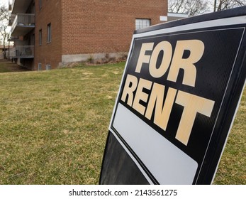 Old Weathered Sign For Rent In Front Of A Residential Low Rise Building. Investment Property, Affordable Housing, Real Estate Crisis Concept.