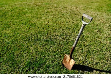 An old weathered spade with a rusty blade