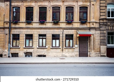 Old Weathered Street Wall With Some Windows And Door