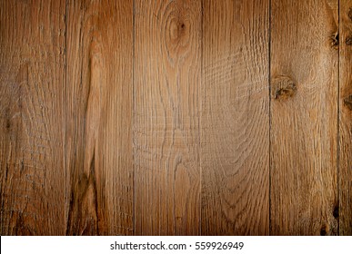 Old Weathered Wood Surface With Long Boards Lined Up. Wooden Planks On A Wall Or Floor With Grain And Texture. Warm Brown And Orange Tones.