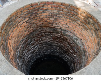 Old Well Made Of Red Bricks Located In Village.