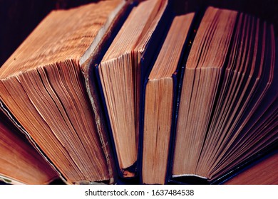 Old and well used hardback books or text books in a book shop or library. Many Books Piles. Hardback books on wooden table top view. Back to school background with copy space - Shutterstock ID 1637484538