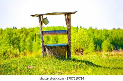 Old Well Water Pump In Rural Garden