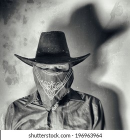Old West Bandit. Old west bandit outlaw with covered face and cowboy hat, edited in vintage film style. - Shutterstock ID 196963964