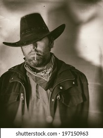 Old West Cowboy Smoker Wide. An old west cowboy smoking a hand rolled cigarette, edited in vintage film style.
