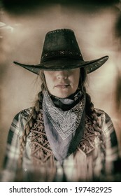 Old West Cowgirl Hat Low Wide. Old west cowgirl with hat low blocking eyes, edited in vintage film style. - Shutterstock ID 197482925