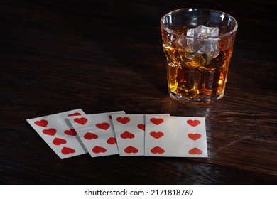 Old West Gambling. Playing cards and whiskey on wooden table