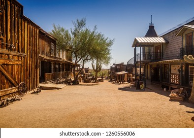 Old Western Goldfield Ghost Town square with huge cactus and saloon, photo taken during the sunny day with clear blue sky
