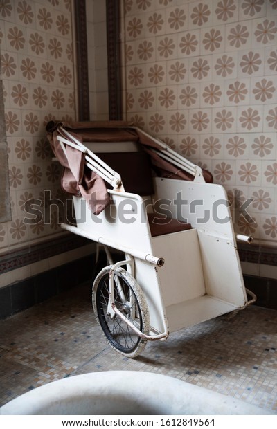 Old wheelchair in an\
abandoned hospital