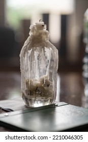 Old Whiskey Bottle Used As A Candle Holder And Menu