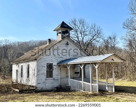 Old white abandoned church building with steeple, in decay. Rural southern Ohio. 