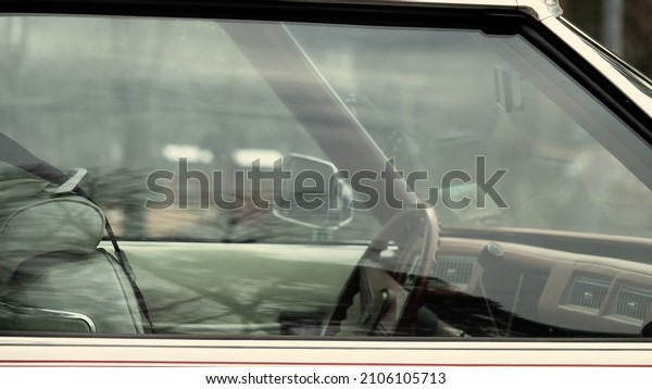 old white car, View into the cab of the car through\
the glass