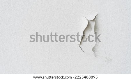 Old white color paint wall Background Cracked, Broken rough cement surface vintage style and Ungualified paint