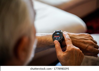 old white haired man using smart watch checking his cardiogram ecg - Shutterstock ID 1778980295