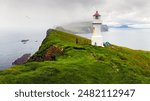 Old white lighthouse on the Mykines island, Faroe islands, Denmark. Landscape photography