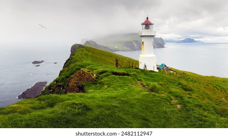 Old white lighthouse on the Mykines island, Faroe islands, Denmark. Landscape photography - Powered by Shutterstock