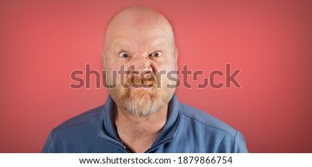 Old white man with a mean, angry expression on his wrinkled face