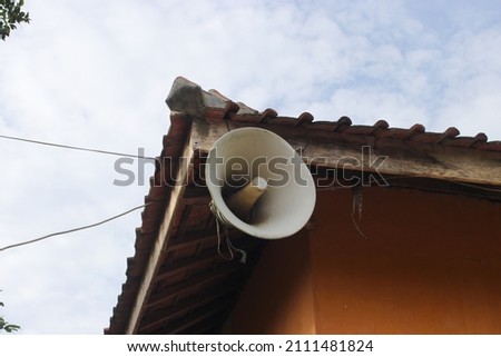 Old white speaker in the corner of an old mosque in a rural area in Indonesia