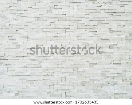 Old white stone brick wall vintage texture background,Wallpaper patter grid surface,Stone wall vintage texture background