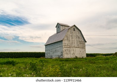 Old white wooden barn on a cloudy afternoon.  Stark County, Illinois, USA