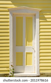 Old White And Yellow Door On The Exterior Of Clapboard House