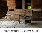 OLD WICKER CHAIR IN MID-19TH CENTURY BARN