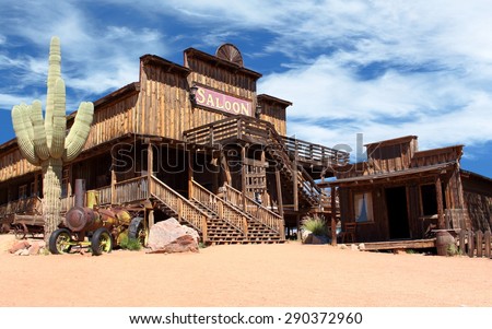 Old Wild West desert cowboy town with cactus and saloon 